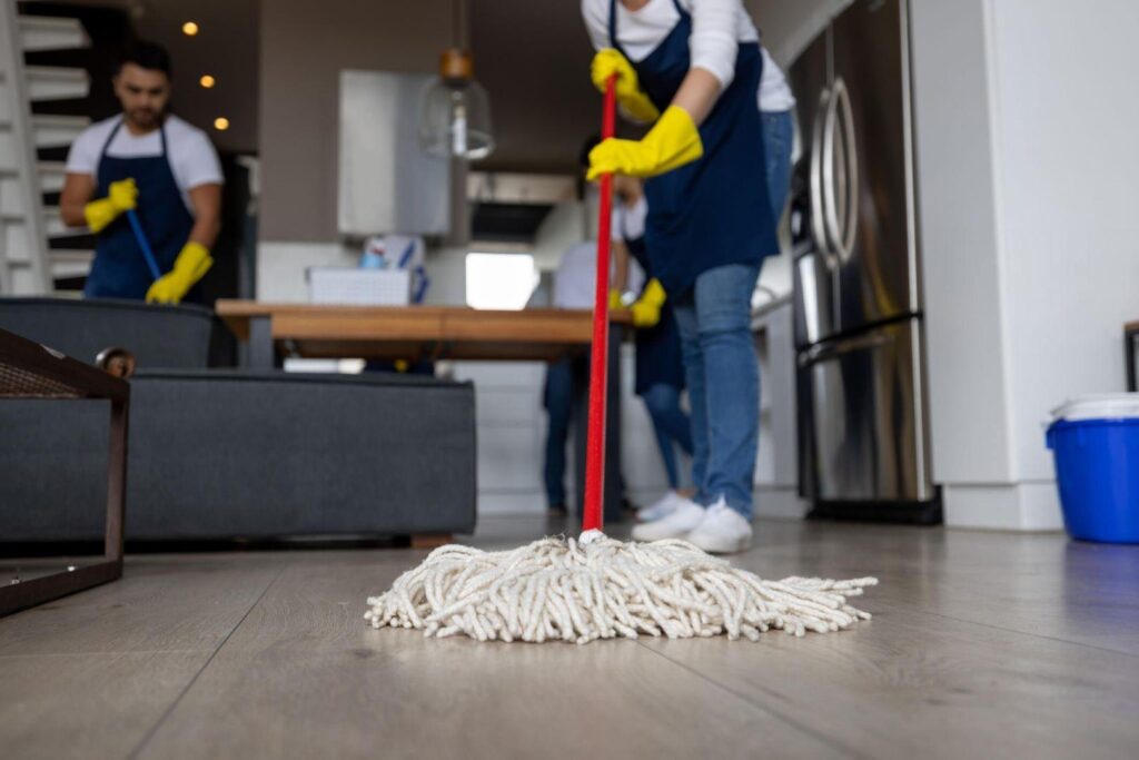 Commercial Cleaner pushing a string mop