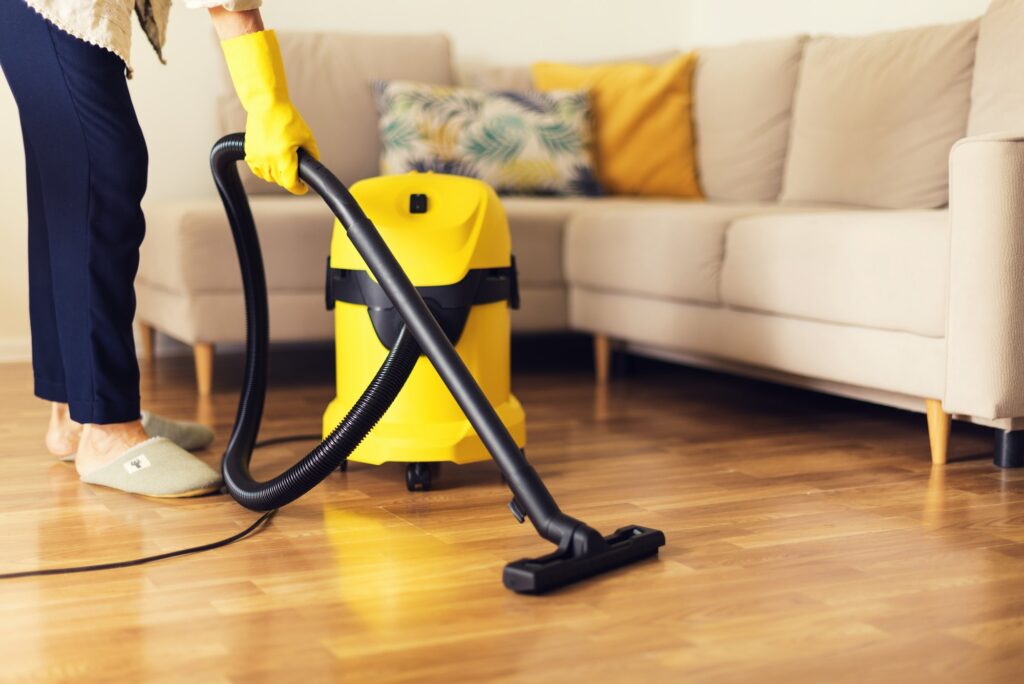 Yellow vacuum cleaner on hardwood office floor