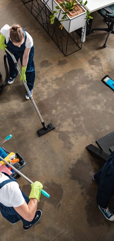 Looking down on office cleaners cleaning floor and stairs