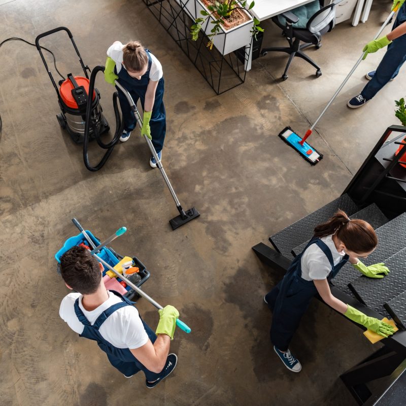 Looking down on office cleaners cleaning floor and stairs