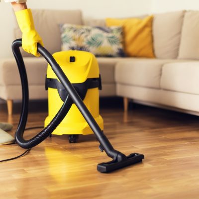 Yellow vacuum cleaner on hardwood office floor